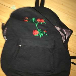 Black backpack with rose on front